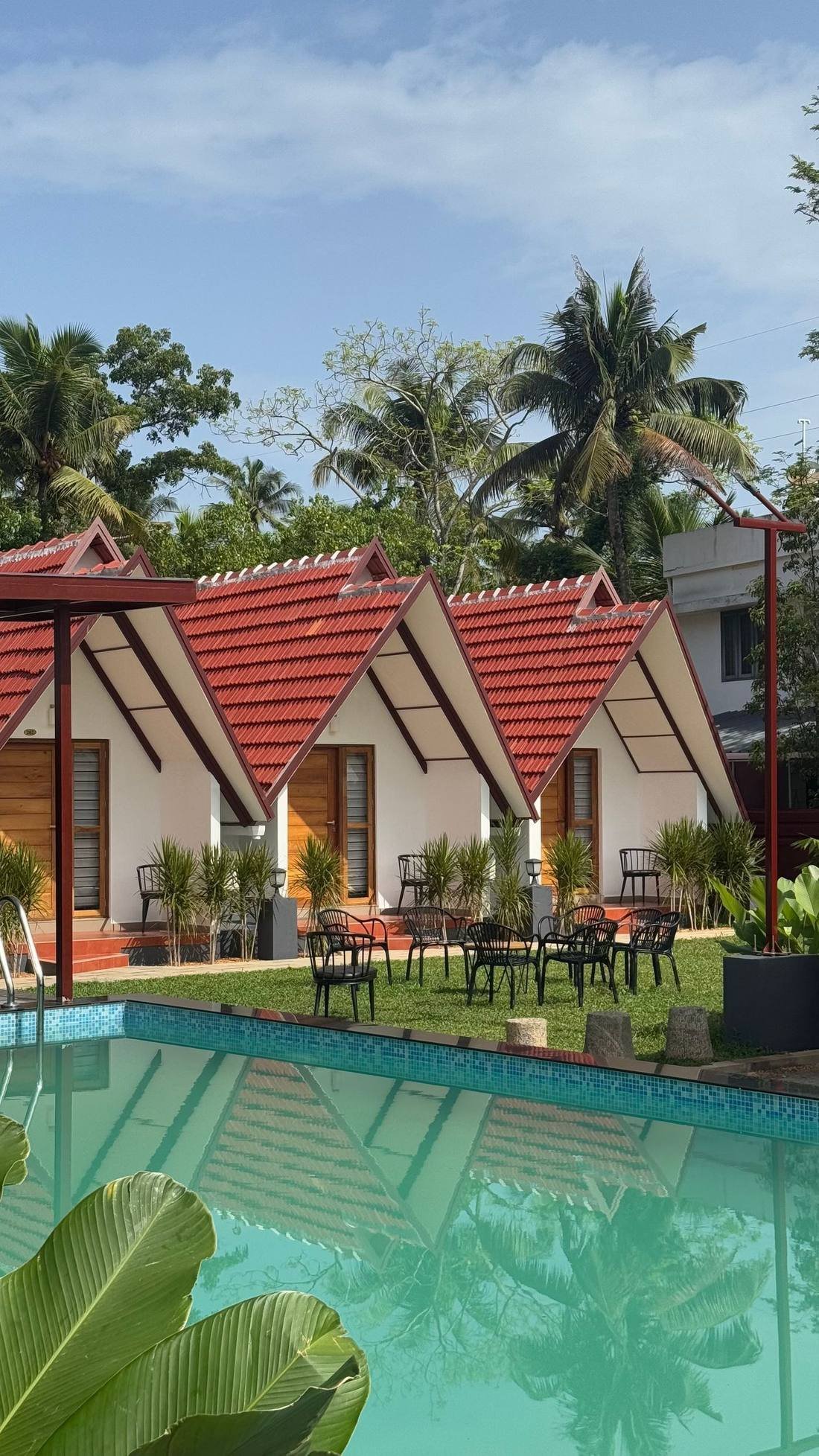 Traditional Kerala wellness resort with red-roof cottages